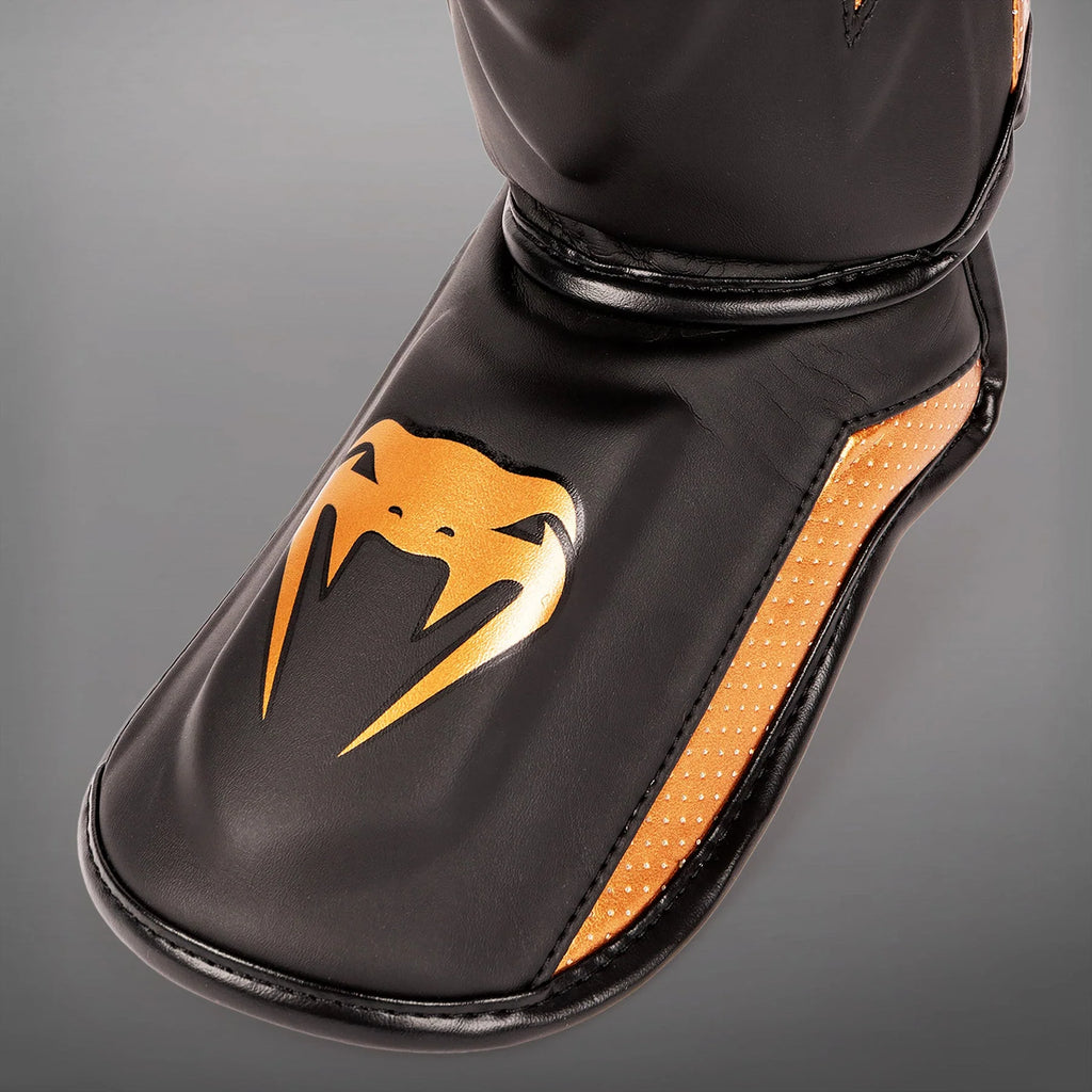Espinilleras Venum Elite Evo  - Negro/Bronce